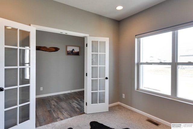 interior space featuring recessed lighting, french doors, baseboards, and visible vents