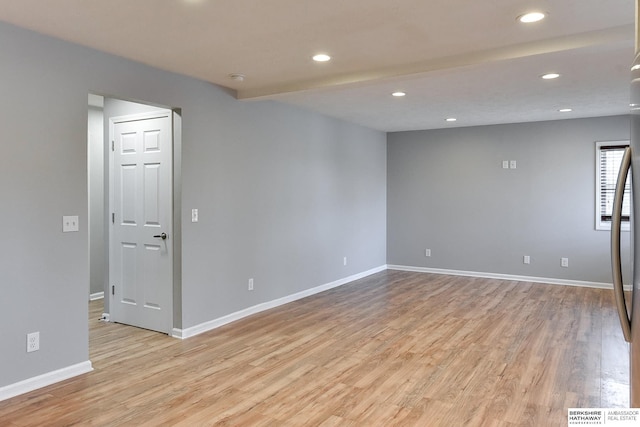 unfurnished room featuring recessed lighting, light wood-type flooring, and baseboards