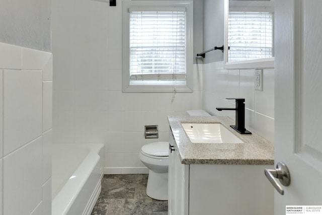 bathroom featuring toilet, a tub, tile walls, walk in shower, and vanity