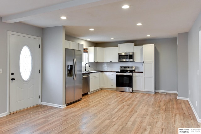 kitchen featuring visible vents, light wood-style flooring, recessed lighting, stainless steel appliances, and white cabinetry