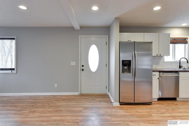 entryway featuring beamed ceiling, recessed lighting, baseboards, and light wood finished floors