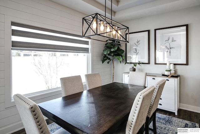 dining room featuring baseboards and dark wood-style flooring