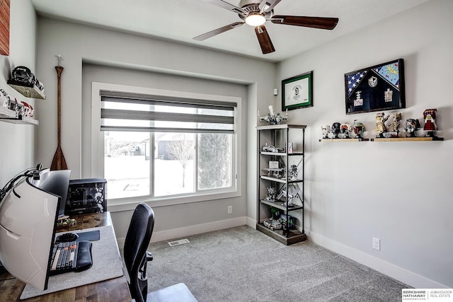 carpeted office space with visible vents, baseboards, and ceiling fan