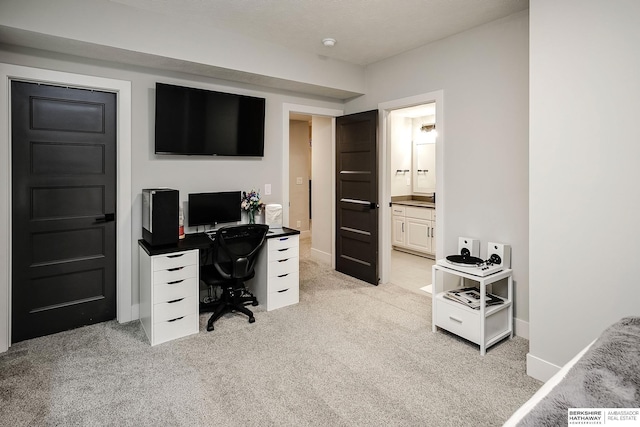 home office with light colored carpet and baseboards