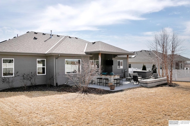 back of house with a patio, fence, a shingled roof, a hot tub, and outdoor dry bar