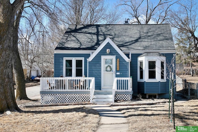 view of front of house featuring a gate and a shingled roof