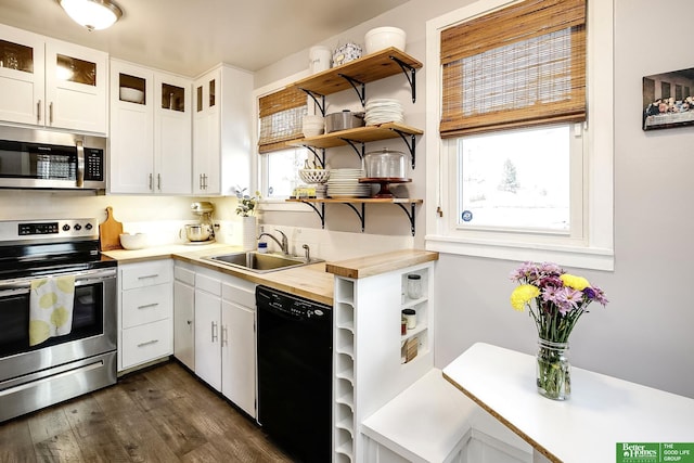 kitchen featuring open shelves, stainless steel appliances, light countertops, and a sink