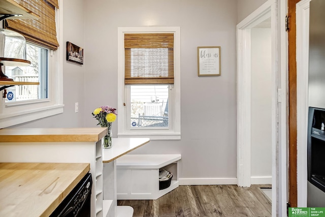 interior space with wood finished floors and baseboards