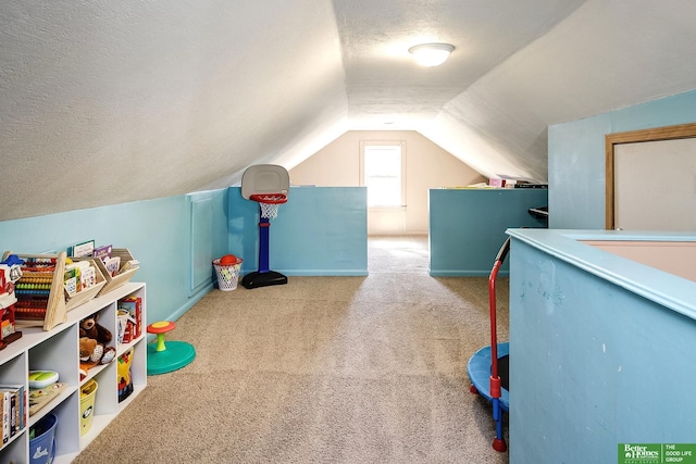 game room with lofted ceiling, a textured ceiling, and carpet