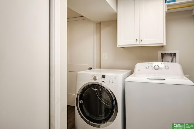 clothes washing area featuring washer and dryer, cabinet space, and wood finished floors