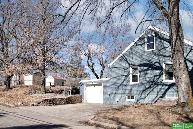 view of home's exterior with an attached garage and driveway