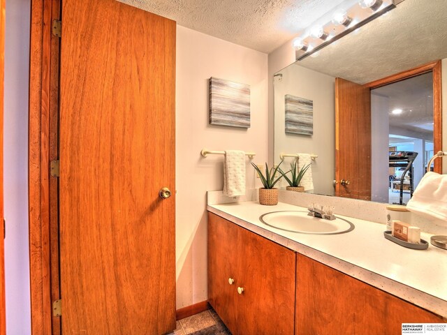 bathroom featuring a textured ceiling and vanity