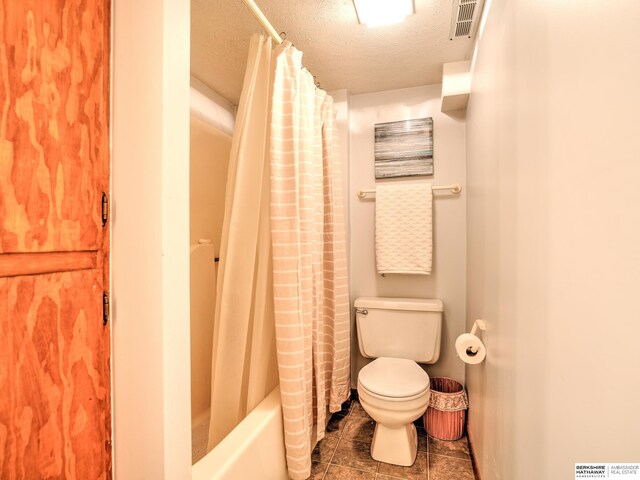 full bathroom featuring visible vents, toilet, a textured ceiling, shower / tub combo, and tile patterned flooring