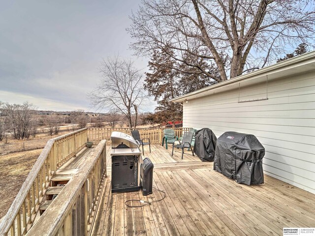 wooden deck featuring a grill