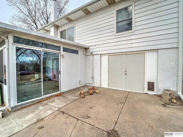 exterior space featuring a chimney and a patio area