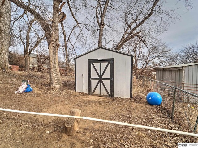 view of shed with fence