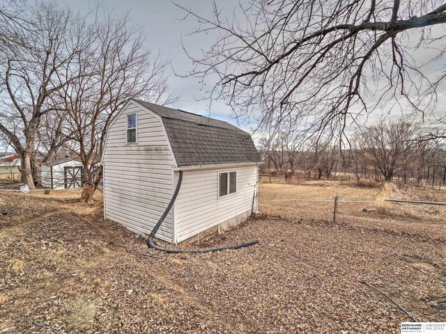 view of shed with fence