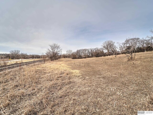 view of yard featuring a rural view and fence