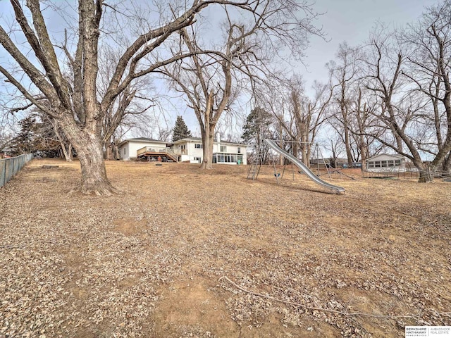 view of yard featuring a playground and fence