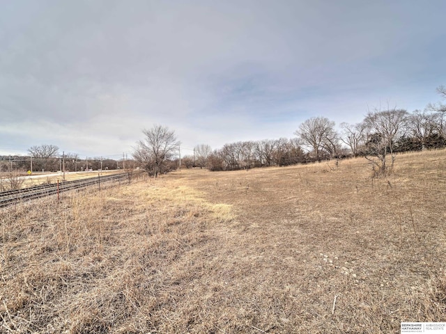 view of yard with a rural view and fence