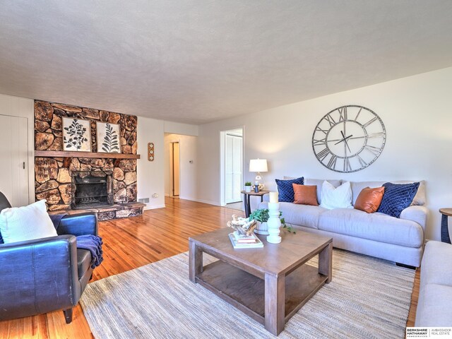 living room with wood finished floors and a fireplace