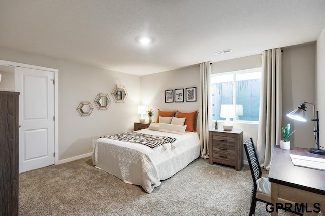 carpeted bedroom with baseboards and visible vents