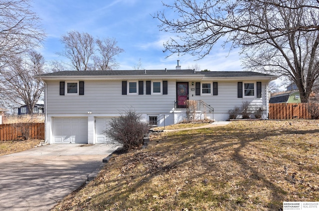 ranch-style house with an attached garage, fence, and driveway