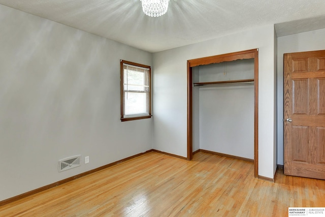 unfurnished bedroom featuring visible vents, baseboards, and light wood-style flooring