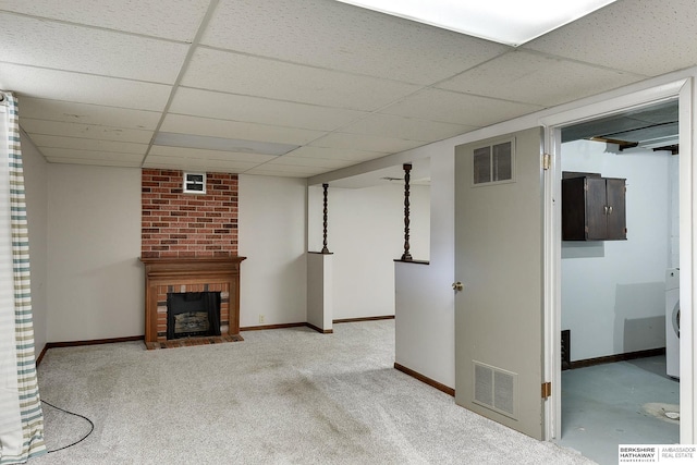 interior space featuring visible vents, a paneled ceiling, baseboards, and a fireplace