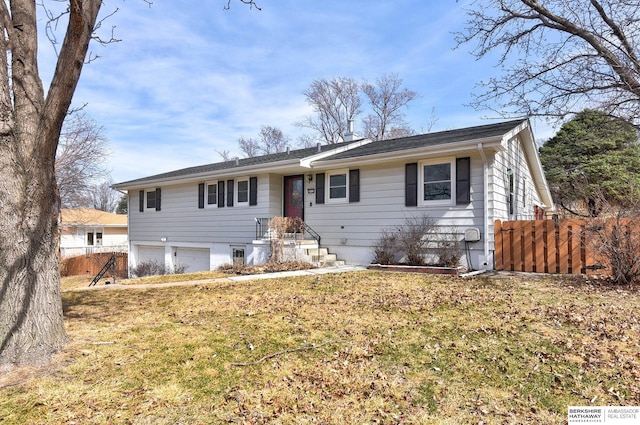 single story home featuring a garage and fence