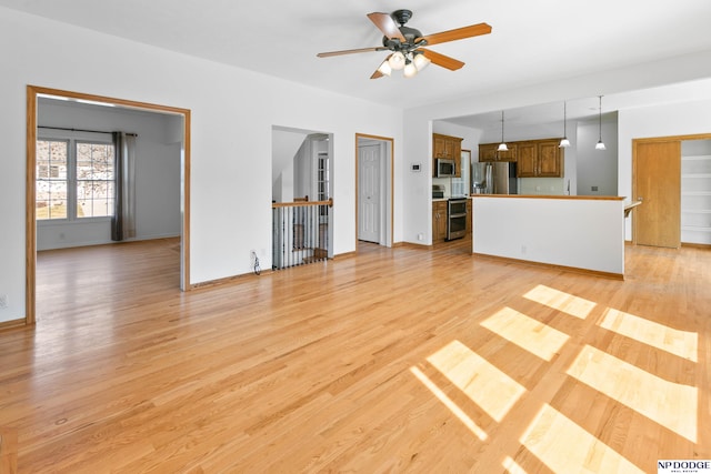 unfurnished living room with light wood-style floors and ceiling fan