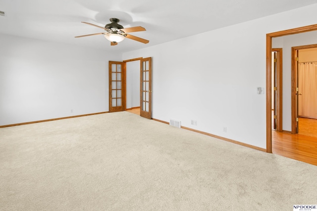 unfurnished room with french doors, visible vents, carpet floors, and baseboards