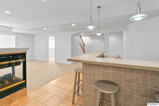 bar featuring decorative light fixtures, recessed lighting, stairway, light tile patterned flooring, and light colored carpet