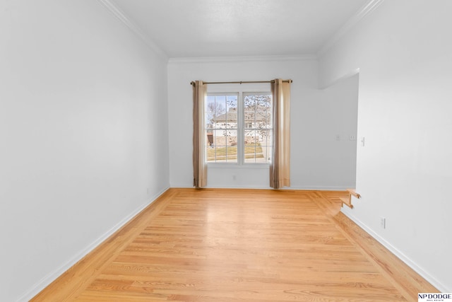 empty room with baseboards, light wood-style floors, and ornamental molding