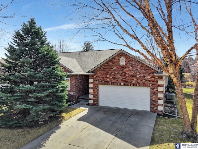 view of front of house featuring an attached garage, brick siding, driveway, and a shingled roof