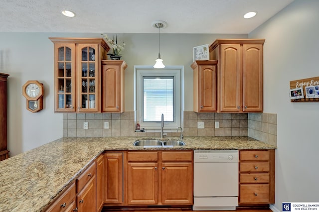 kitchen featuring a sink, glass insert cabinets, light stone countertops, dishwasher, and hanging light fixtures