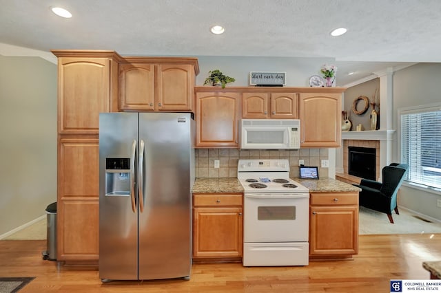 kitchen with baseboards, decorative backsplash, recessed lighting, light wood-style floors, and white appliances