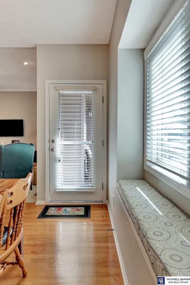 doorway to outside featuring light wood-style floors and baseboards