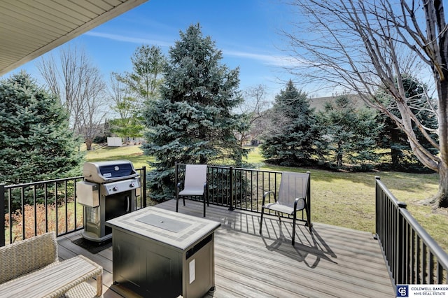 deck featuring area for grilling and a lawn