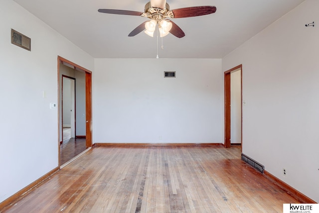 empty room with visible vents, baseboards, and light wood-style flooring