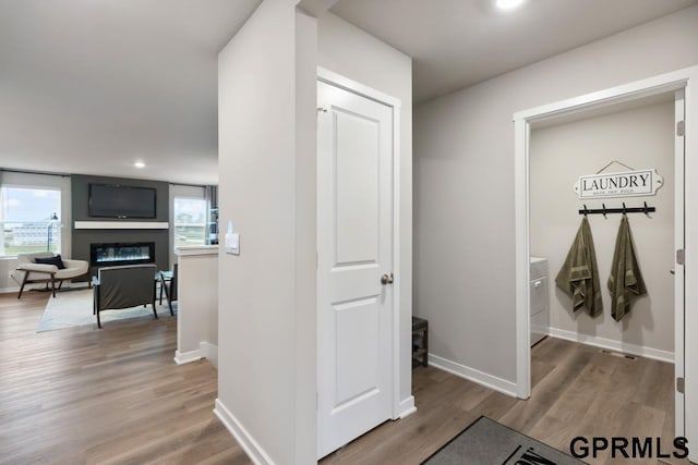 corridor featuring wood finished floors and baseboards