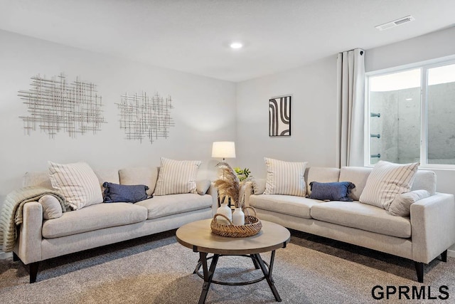 living area featuring recessed lighting and visible vents