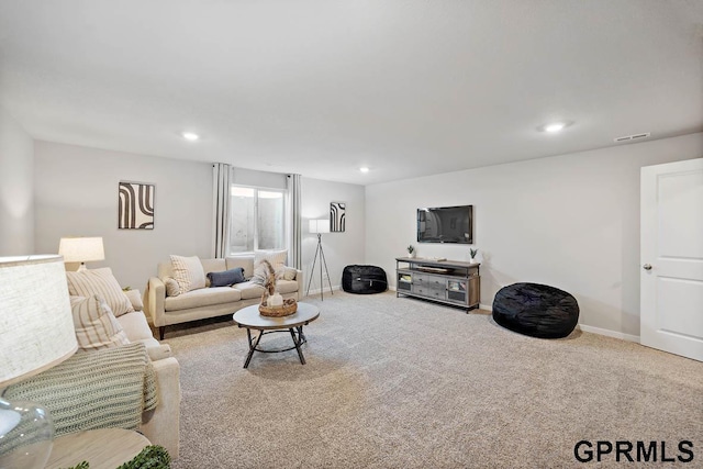 carpeted living area featuring visible vents, recessed lighting, and baseboards