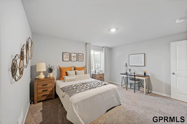 carpeted bedroom featuring visible vents and baseboards