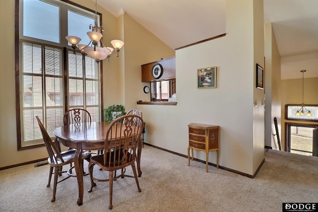 carpeted dining space with an inviting chandelier, baseboards, and a towering ceiling