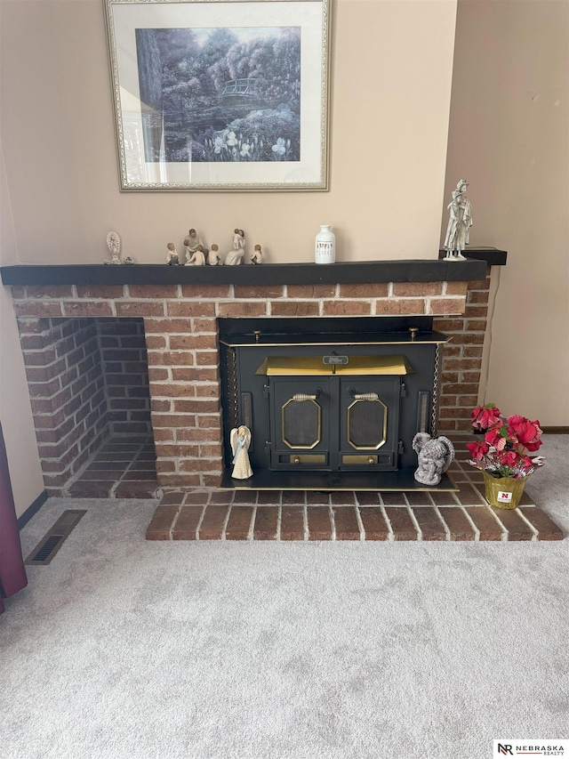 interior details featuring a fireplace, visible vents, and carpet floors