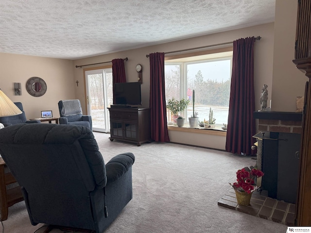 living area with a textured ceiling, a brick fireplace, and light carpet