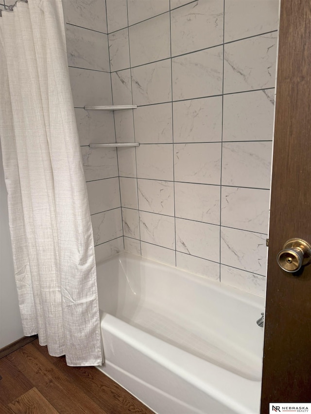 bathroom featuring shower / bath combination with curtain and wood finished floors