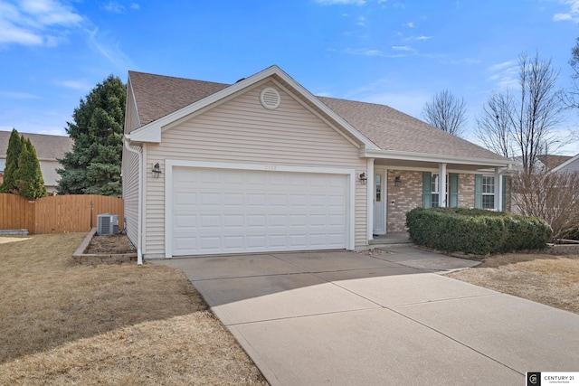 ranch-style home with fence, roof with shingles, concrete driveway, an attached garage, and brick siding