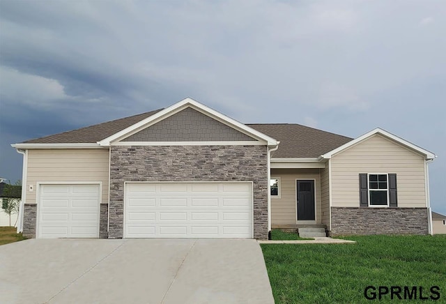 view of front facade with stone siding, driveway, an attached garage, and a front yard